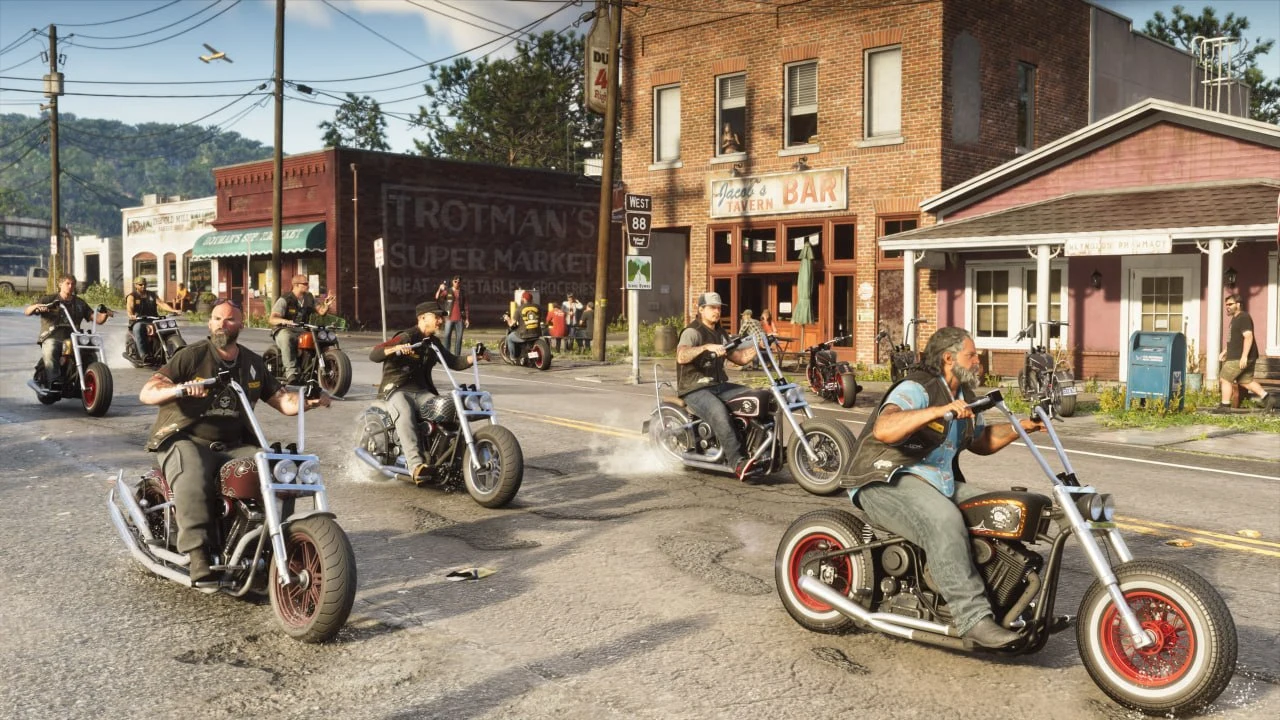 GTA 6 screenshot from Edge — a gang of bikers riding down the main street of a small town past Trotman's Supermarket and a bar