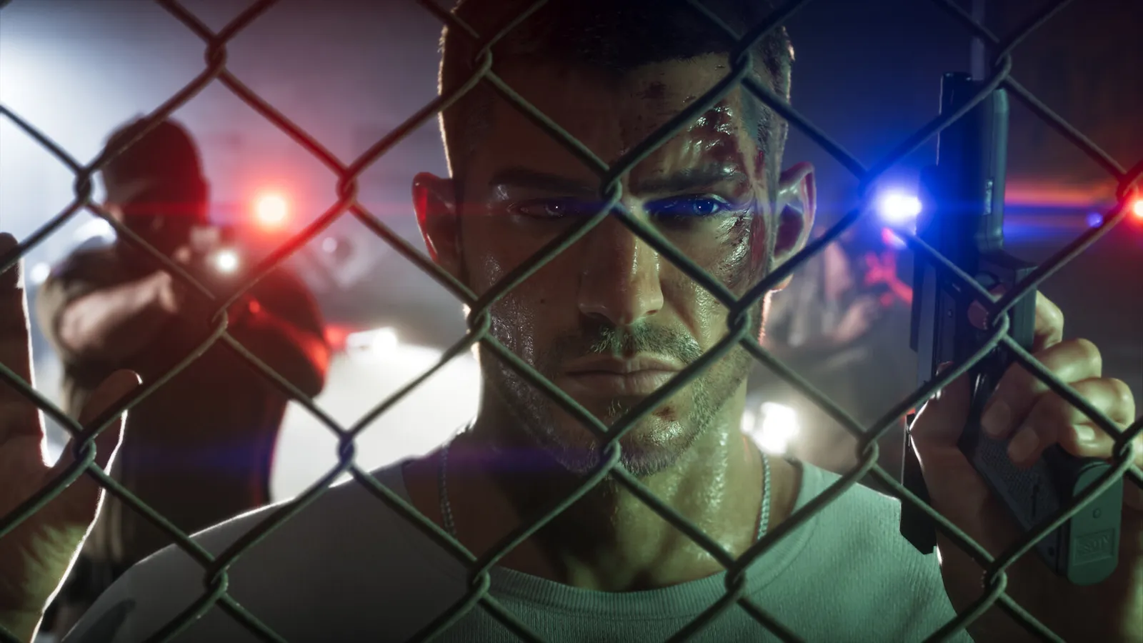 Official GTA 6 screenshot — Jason behind a chain-link fence, red and blue police lights on his face (An Extended Look)