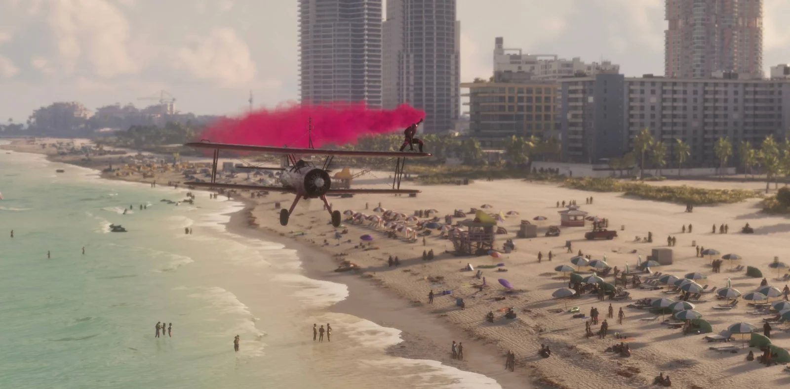 Frame from the GTA 6 Launch Trailer: a biplane trailing pink smoke low over a crowded beach in front of Vice City hotels