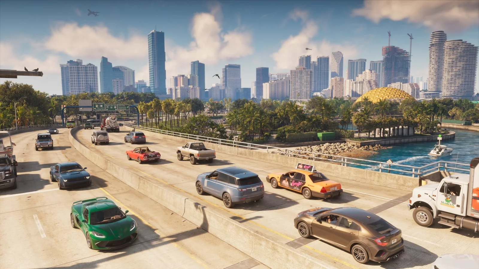 Official GTA 6 screenshot: a busy multi-lane highway with cars, a taxi and a truck heading into the Vice City skyline (released October 8, 2026)