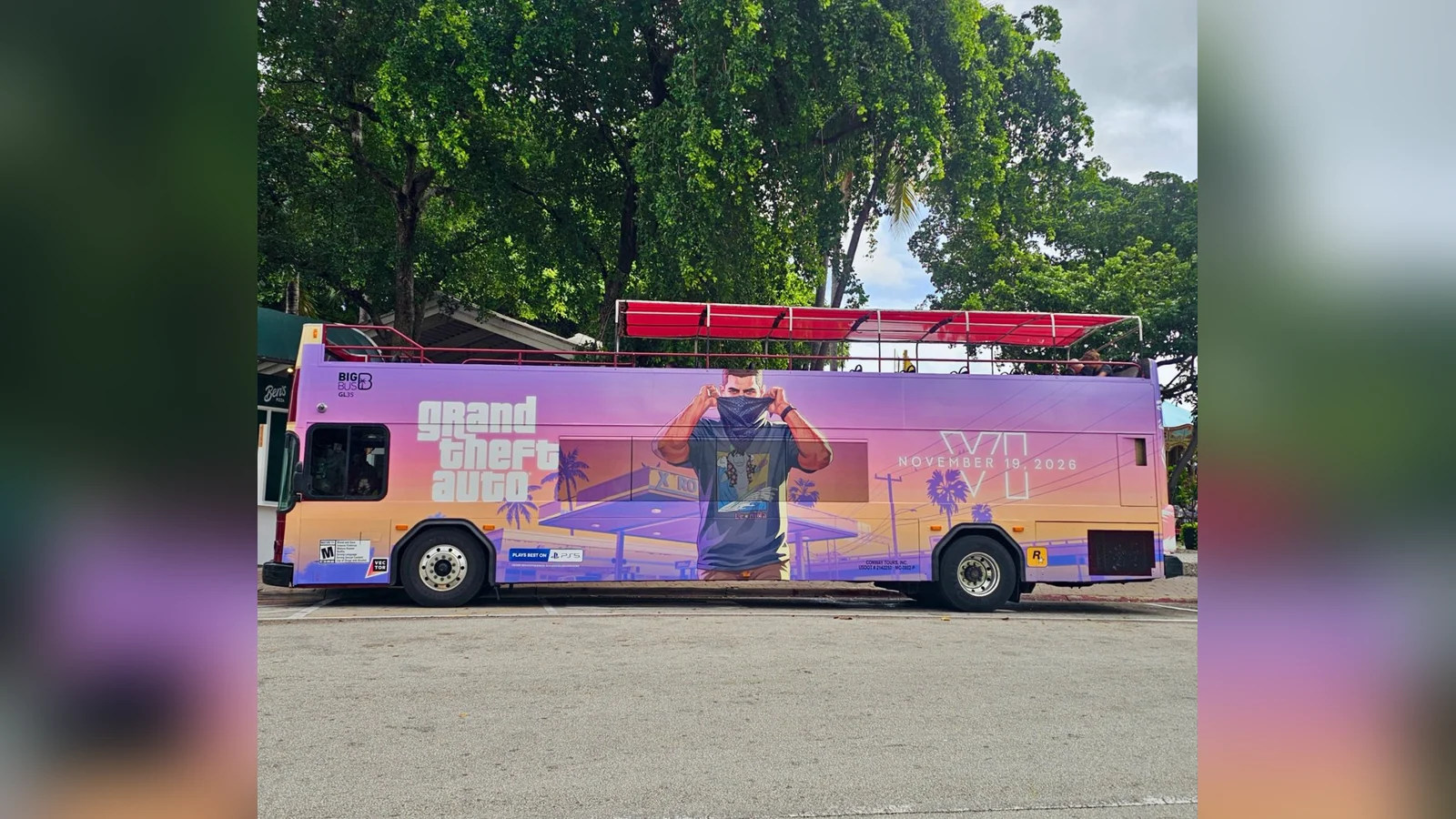 Open-top double-decker sightseeing bus in Miami wrapped in GTA 6 art: Jason pulling up a bandana at a Xero gas station, the logo and November 19, 2026