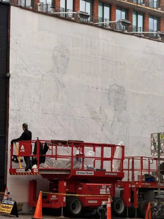 Pencil outline of a GTA 6 mural on a white brick building wall in Williamsburg, Brooklyn, with a painter on a red lift (photo shared online)