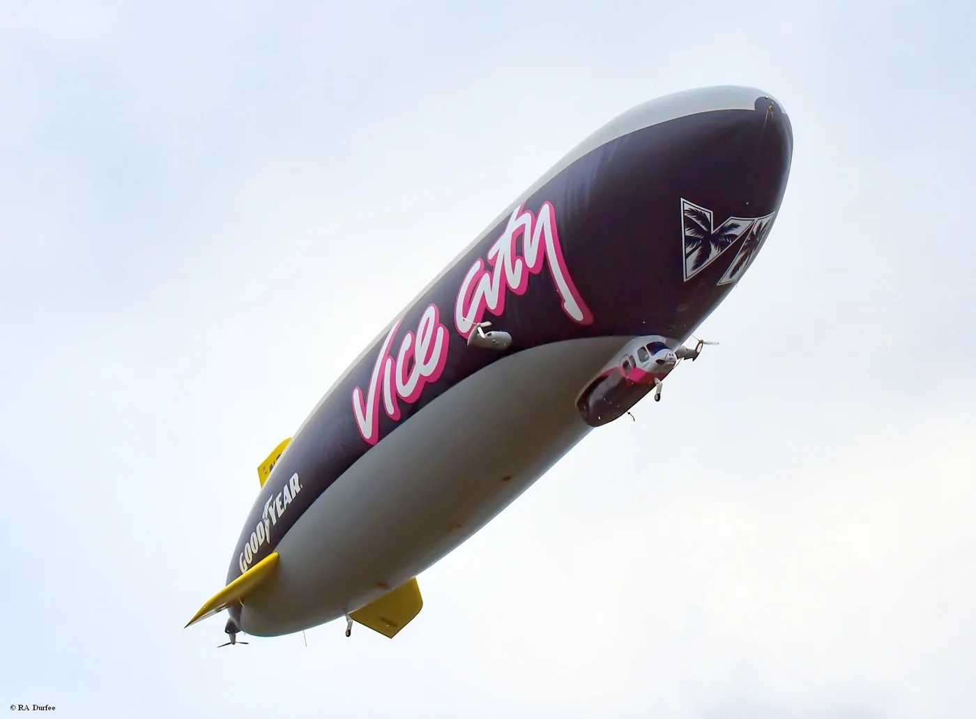 Underside of the Goodyear blimp in the GTA 6 Vice City livery, with the VI logo near the nose (photo: RA Durfee)